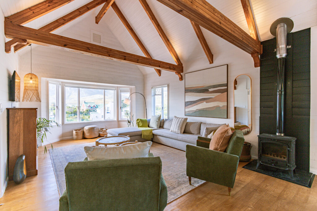 Warm timber living room with fireplace at Sugarbird Cabin