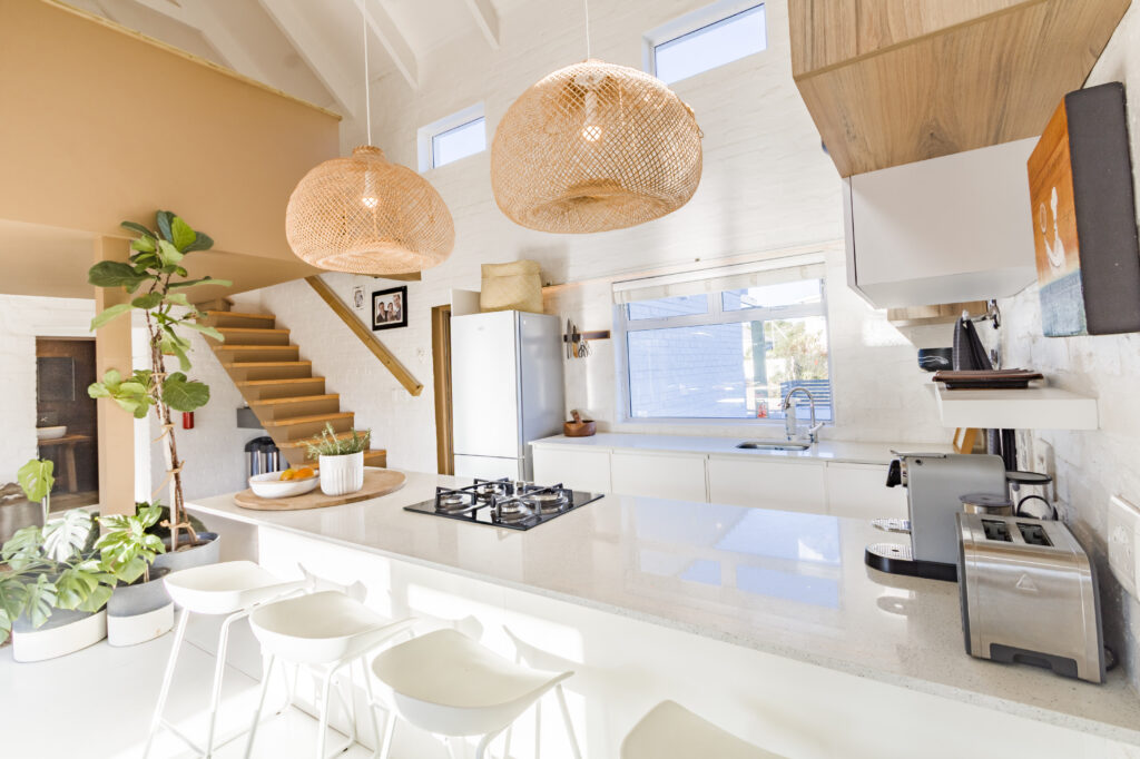 Woven pendant lights, timber stairs and a bright kitchen at The Blue Door