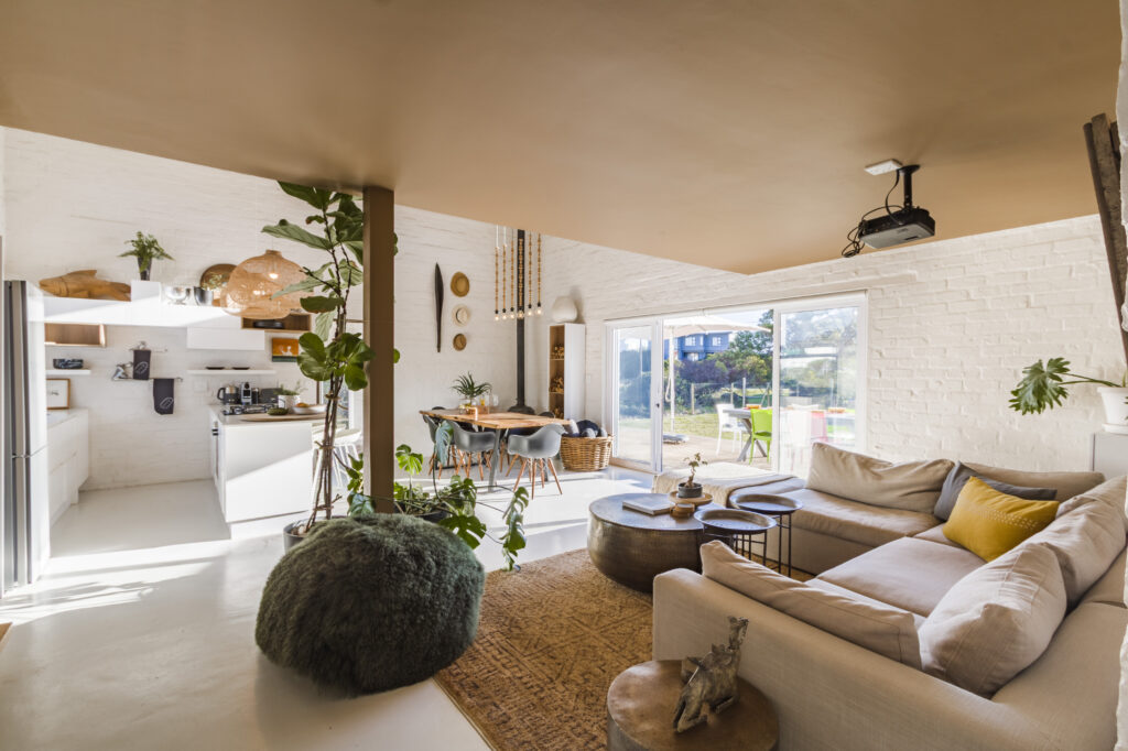 Light-filled living and dining space with woven pendants at The Blue Door
